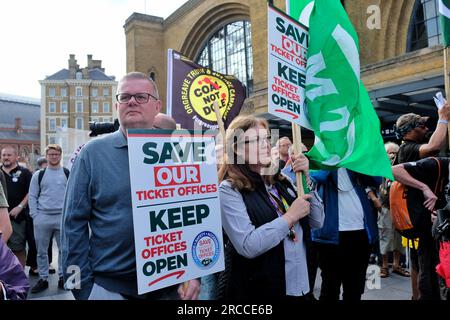 London, UK. 13th July, 2023. Rally attendees hold placards saying: 'Save our ticket offices' and Keep ticket offices open'. After it was announced that the Rail Delivery Group planned up to 1,000 ticket offices in the next three years, the Rail, Maritime and Transport Union (RMT) stepped up their campaign of resistance with a National Day of Action. Trade union members, disablity action groups and MPs joined the rally outside King's Cross Station over access and safety concerns. Credit: Eleventh Hour Photography/Alamy Live News Stock Photo