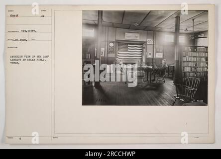 Interior view of the Camp Library at Kelly Field, Texas. The library was a space provided for servicemen stationed at the field to have access to books and reading materials. This photograph, taken by photographer Sig, shows the rows of bookshelves and tables inside the library. Stock Photo