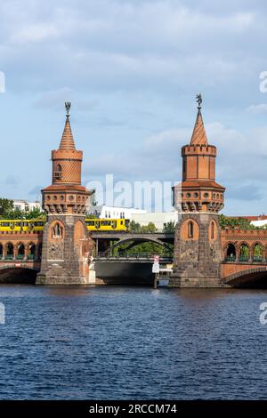 The beautiful Oberbaumbruecke in Berlin with a yellow metro train Stock Photo