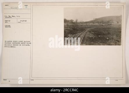 Photograph taken by Lt. Wm. Fox, S.C., shows a 30 meter curve on a light railway. In the distance, a meter gauge railroad bridge can be seen destroyed. The location is Bouillonville. This photo was issued on 02 number 1-23-19 and received under reference number 46447 335-F9. Stock Photo