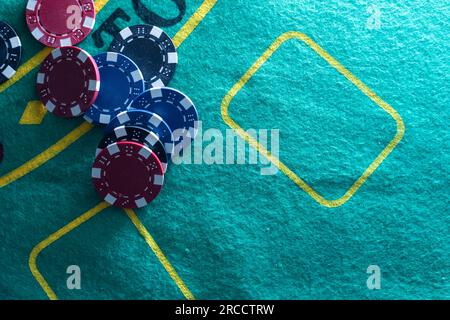 Image of several red dice falling on green table on background of multicolored spots Stock Photo