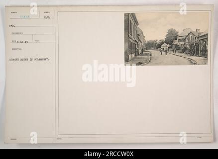 American soldiers patrolling the streets of Folembray during World War One. The image shows buildings and a few local residents going about their daily activities. The soldiers are wearing their uniforms and appear to be on alert as they move through the town. Stock Photo