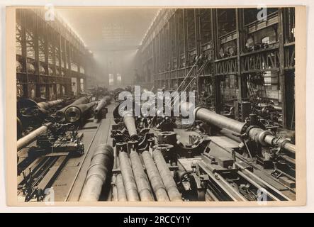 Workers at Bethlehem Steel Company in Bethlehem, Pennsylvania, prepare to rifle a 14' gun on the left while 12' and 14' guns and gun tubes can be seen on the right. This image showcases the industrial activities during World War I. Stock Photo