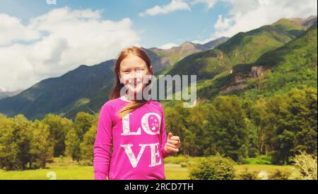 Cute little girl hiking in swiss Alps. Image taken in Simplon pass, border between Switzerland and Italy Stock Photo