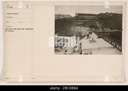 American engineers in France constructing a dam. The photograph, taken by Signal Corps photographer RECO, depicts the dam built during World War I. The image is numbered 61,709 and is part of the collection 'Photographs of American Military Activities.' It was taken in 188UEDI. Additional information identifies the dam as symbol E and includes notes referencing 9061709. Stock Photo