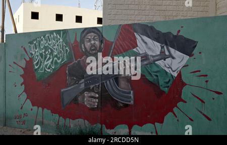A painted wall depicting a Palestinian gunman sits on display at a ...
