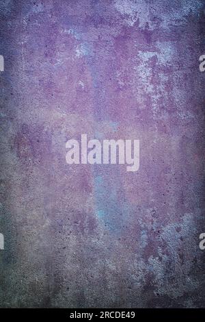 Closeup of old concrete wall in purple and blue Stock Photo