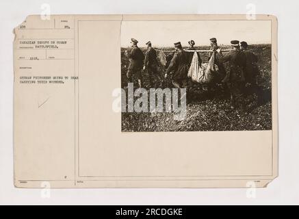 German prisoners carrying wounded comrades on the Somme battlefield during World War One. Canadian troops can be seen in the background. This photograph, taken in 1918, shows German prisoners of war being escorted to the rear to provide medical treatment for their injured fellow soldiers. Stock Photo