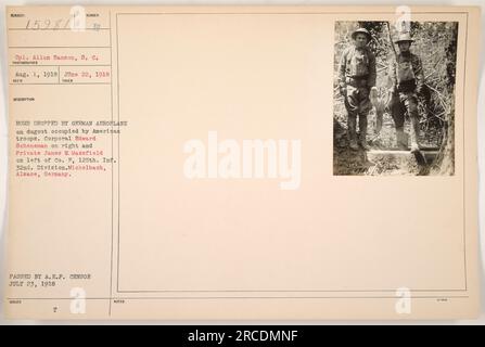 Cpl. Allan Hanson of the Signal Corps captured a photo on August 1, 1918, showing the aftermath of a bombing incident. A German airplane dropped a bomb on a dugout occupied by American troops in Michelbach, Alsace, Germany. The soldiers pictured are Corporal Edward Scheneman on the right and Private James V. Maxsfield on the left, both from Company F of the 125th Infantry Regiment, 32nd Division. This photo was passed by the American Expeditionary Forces (A.E.F.) censor on July 23, 1918. Stock Photo