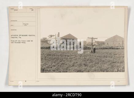 View of the power line to the machine shop at the Aviation Experiment Station in Hampton, VA. This photograph was taken as part of documenting American military activities during World War One. The image shows the power line connecting the machine shop, where various experiments related to aviation were conducted. Stock Photo