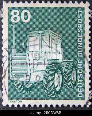 ISTANBUL, TURKEY - JANUARY 25, 2021: German stamp shows Tractor circa 1975 Stock Photo