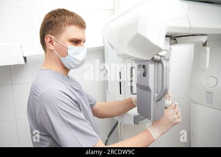 Dental diagnostic examination, dental x-ray equipment, nurse with woman patient. Panoramic radiography, medical technology Stock Photo