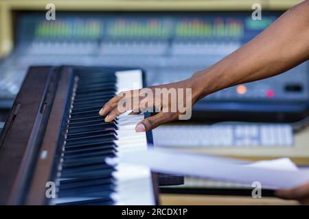 Hands pressing playing keyboard piano buttons Musical sound instruments equipment production Stock Photo