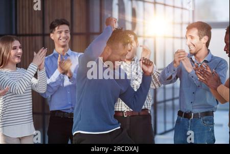 happy multiracial colleagues coworkers celebrate business success together Stock Photo