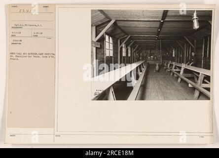 The image shows the mess hall and kitchen of Camp Hospital 64 in Chatillon sur Seine, Cote d'Or, France during World War One. Taken by Sgt. A.L. Villanova on April 11, 1919, the photograph depicts a busy and functional food preparation area. Stock Photo