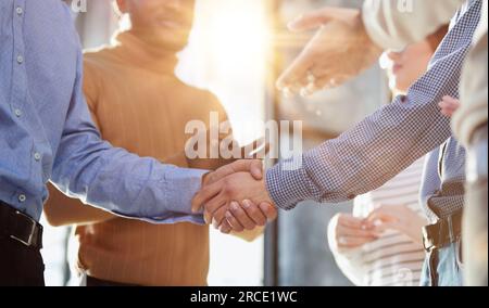 Closeup of business shaking hands over a deal Stock Photo