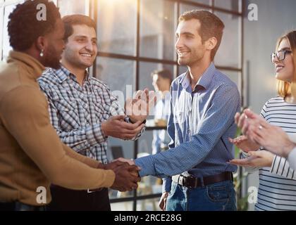 Two happy diverse professional business men executive leaders shaking hands at office meeting. Stock Photo
