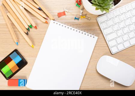 Back to school concept. Top view photo of notepads, pens, sharpeners, ruler, staplers, clips, markers and erasers on wooden table Stock Photo