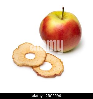 Dried apple chips and a fresh Elstar apple isolated on white background Stock Photo