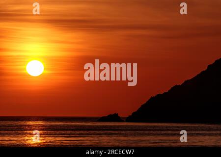 Sunset over the sea at Church Bay, Anglesey, North Wales Stock Photo