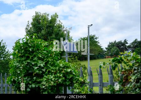 Solar and wind powered surveillance camera on a rail crossing Stock Photo