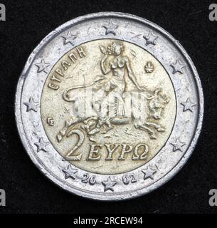 Back, national side of 2 Euro coin from Greece shows a mythological scene from a mosaic in Sparta showing abduction of princess Europa by Zeus, minted Stock Photo