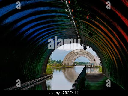 View of Falkirk Wheel from lit up dark Roughcastle tunnel on Union Canal, Scotland, UK Stock Photo