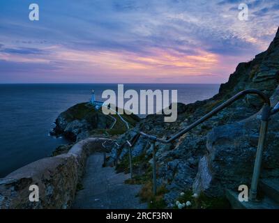 There are 400 steps in the steep climb down to South Stack Lighthouse, followed by a bridge over the wild Atlantic Ocean Stock Photo