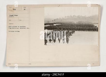 Soldiers from the 29th Division participate in a division review at Camp McClellan, Anniston, Alabama. The photograph, labeled NURER 111-SC-5503, was taken by a Signal Corps photographer during World War One. This image shows the division engaged in training activities. Caption: Division review, Camp McClellan. Stock Photo