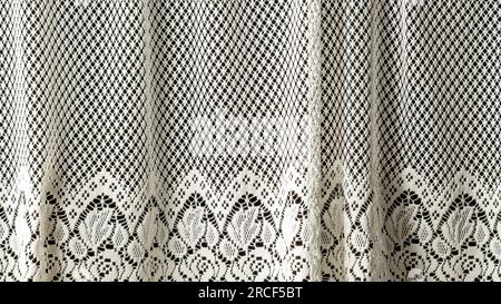 White openwork lace background texture. White guipure fabric with
