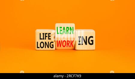 Lifelong learning working symbol. Concept word Lifelong learning working on block on a beautiful orange background. Business educational lifelong lear Stock Photo