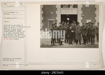 Cpl. W.S. Legge, S.C., captured an image of Secretary of War Newton D. Baker accompanied by various military officers during their visit to Hdqrs. 8.0.8.L in Tours, France. The group consisted of Brig Gen. Johnson Hagood, General Tasker H. Bliss, Col. L.H. Bash, Mr. Hosteller, Mr. Ryan, and Major General Harbord. General Russell was also present. Date of the photograph was not specified. The image was released by A.E.F.Censor but specific release date was not mentioned. Stock Photo