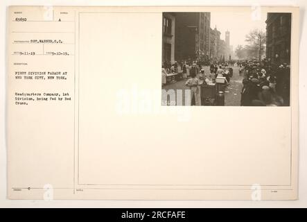 Soldiers from the Headquarters Company of the 1st Division are being provided with food by the Red Cross during a parade in New York City. The photo was taken by photographer S.C. Warner on September 10, 1919, and it is identified as photo number 63630 in the collection. Stock Photo