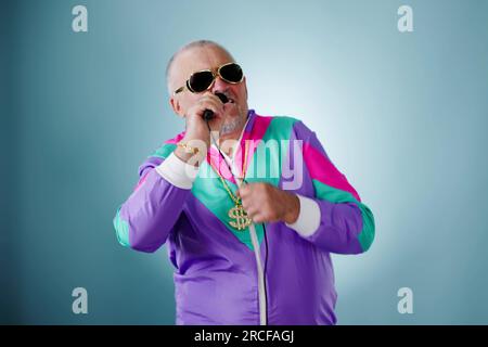 Rich Man In Disco Club Singing. Gold Chain Stock Photo