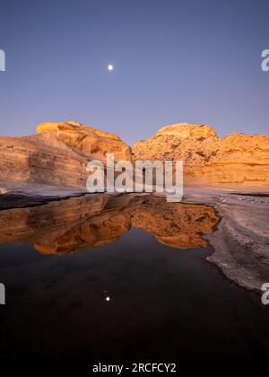 Moonset/sunrise over a tidepool at Punta Colorada, San José Island, Baja California Sur, Mexico. Stock Photo