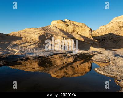 Moonset/sunrise over a tidepool at Punta Colorada, San José Island, Baja California Sur, Mexico. Stock Photo