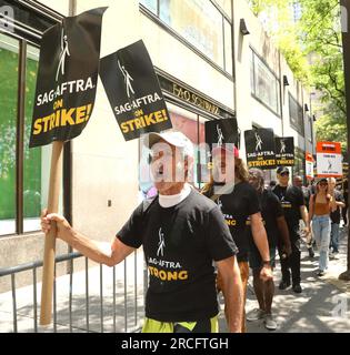 July 14, 2023, New York City, New York, USA: Picketers hold signs outside NBC Universal during the SAG-AFTRA strike in NYC. Actors are demanding a new contract with better wages, benefits and protections against AI. (Credit Image: © Nancy Kaszerman/ZUMA Press Wire) EDITORIAL USAGE ONLY! Not for Commercial USAGE! Stock Photo