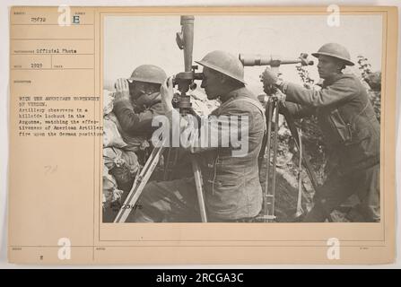 Artillery observers from the American military can be seen in a 1919 photograph titled '111-SC-23672.' The image shows the observers situated northwest of Verdun in the Argonne region during World War I. They are actively monitoring and assessing the impact of American artillery fire on the German position. The official photo, with the ISSUED NUMBER, captures the importance of precision aiming and effectiveness in military operations. Stock Photo