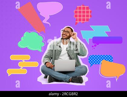 Communication, dialogue. Smiling young man with laptop on dark violet background. Different speech bubbles around him Stock Photo