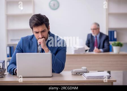 Two colleagues working at workplace Stock Photo