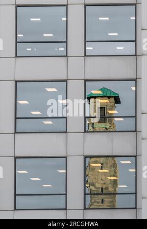 Reflection of the Civic Centre Clock Tower in the windows of an office building in the city centre of Southampton, Hampshire, England, UK Stock Photo