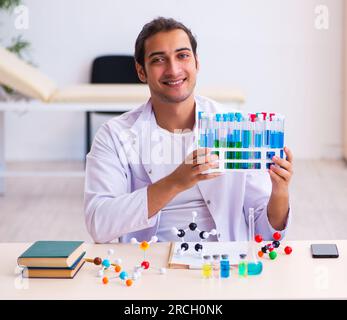 Young male chemist student working in the lab Stock Photo