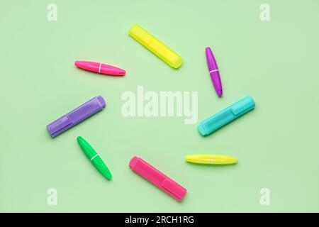 Frame made of colorful markers on green background Stock Photo