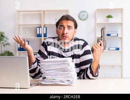 The young employee feeling like prisoner at work Stock Photo