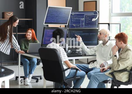 Team of young programmers working in office Stock Photo