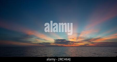 The morning sea and the sun shine in the middle of the sea Stock Photo