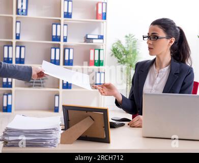 The young female employee being fired from her work Stock Photo