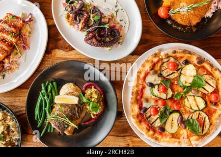 Fresh tasty food. Set of dishes on the table, on a wooden background. Top view. Stock Photo