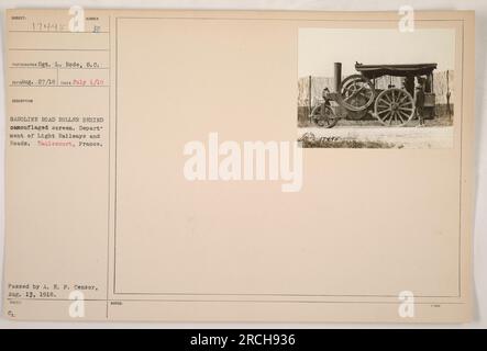 A camouflaged screen conceals a Sumber gasoline road roller operated by the Department of Light Railways and Roads in Raulecourt, France during World War I. This photograph was taken on July 1, 1916 by Sgt. L. Rode. It was officially issued and approved by the A. E. P. Censor on August 13, 1918. Stock Photo