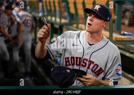 Houston Astros center fielder Jake Meyers signs an autograph after